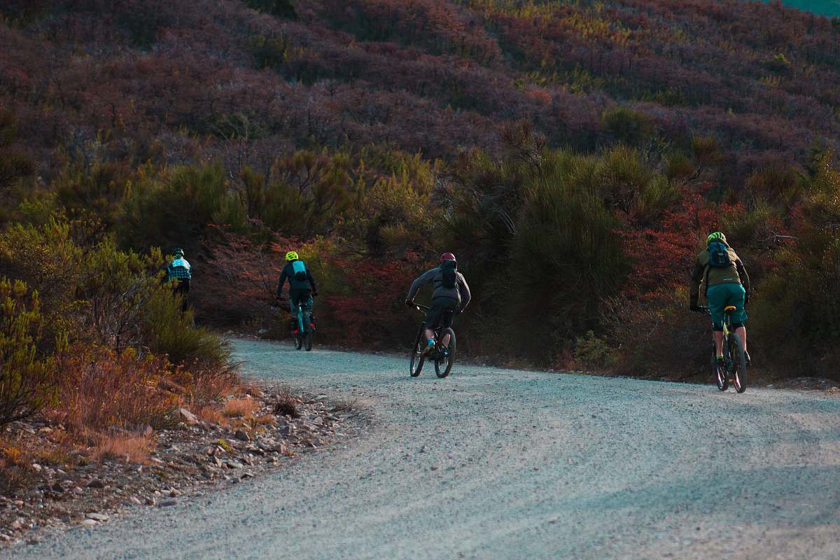 gravel cyclist travelling on gravel trail by the mountain road